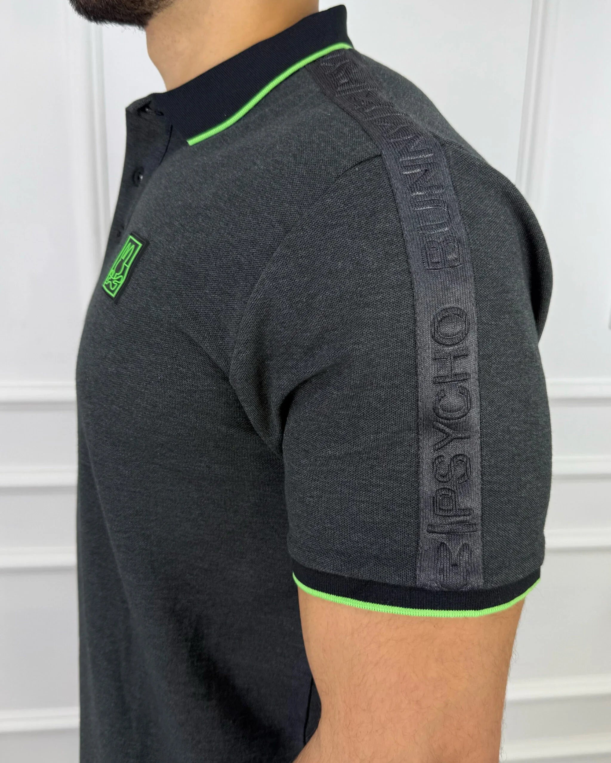 Polo hombre gris con detalles neón verde, cuello y puños contrastantes, diseño moderno y premium